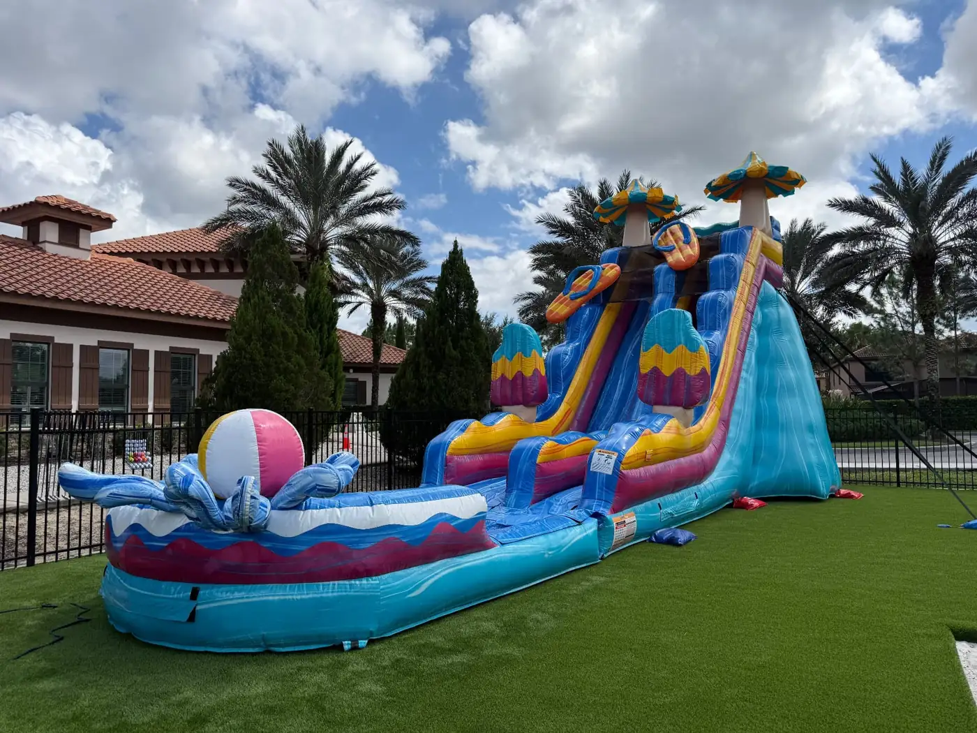 MJT tropical water slide with splash pool on a lawn