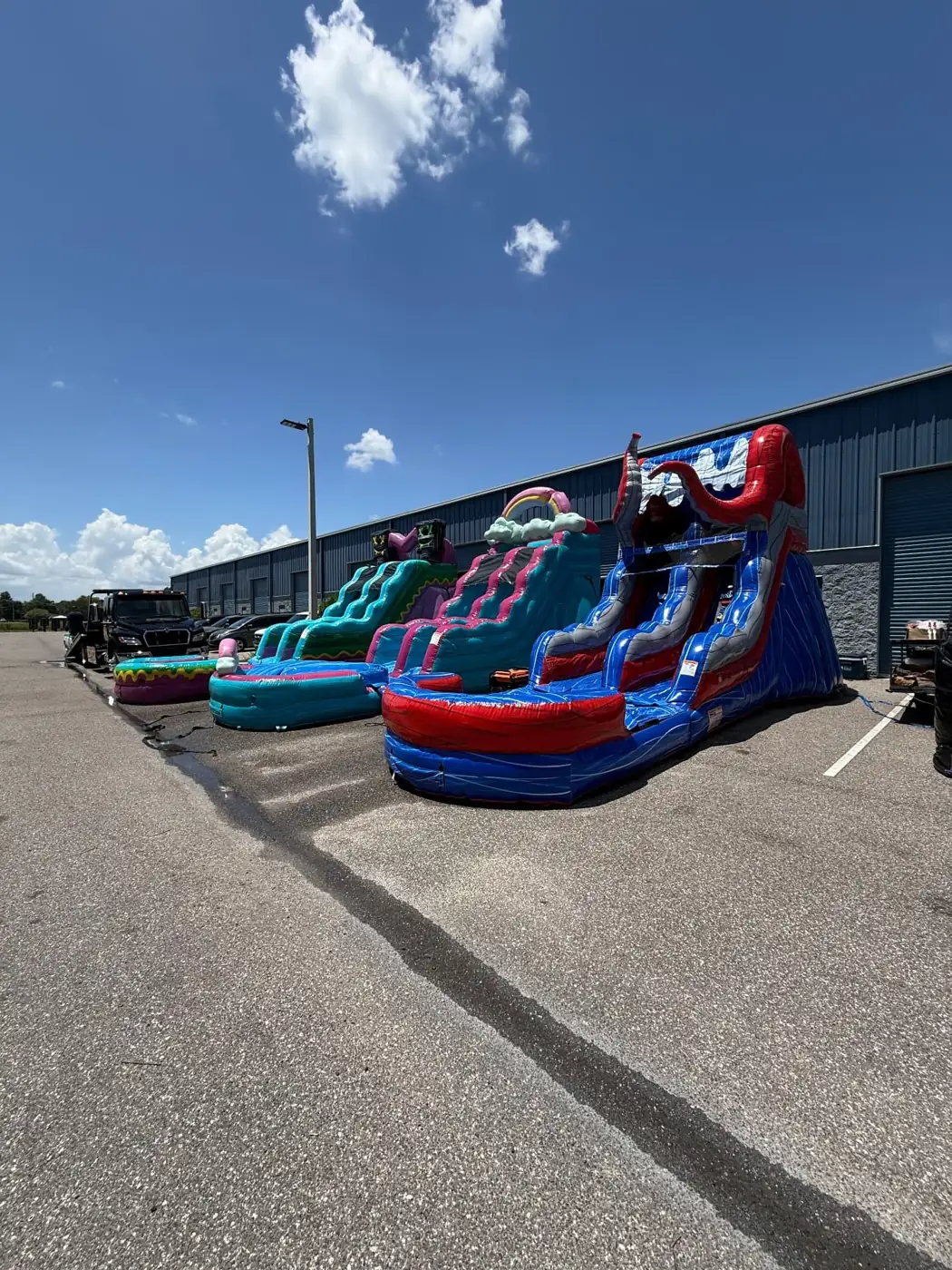 MJT colorful water slides set up outside a building