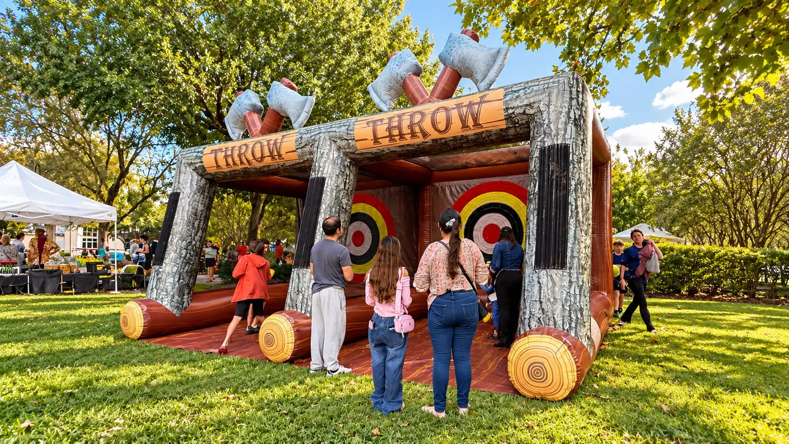 Double Lane Axe Throw inflatable at a fall festival with families waiting to play