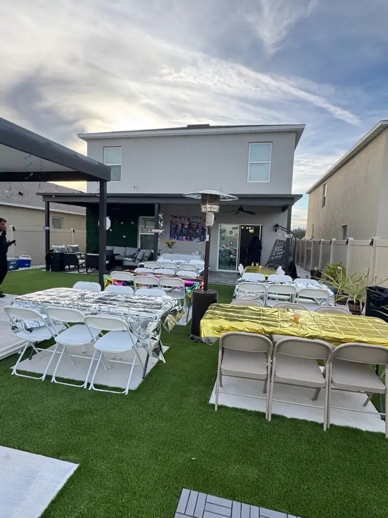 White MJT tables and chairs arranged for an outdoor celebration