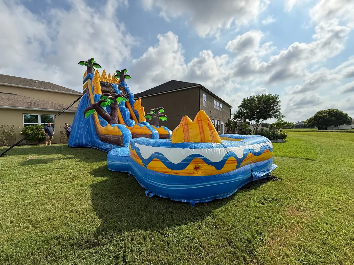 MJT tropical water slide and pool in a backyard