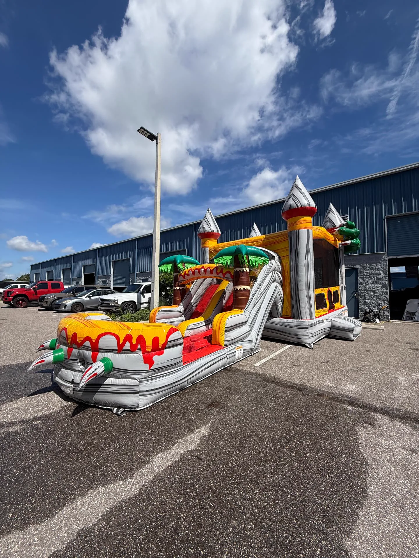 A yellow castle water slide inflated at our warehouse for cleaning and inspection