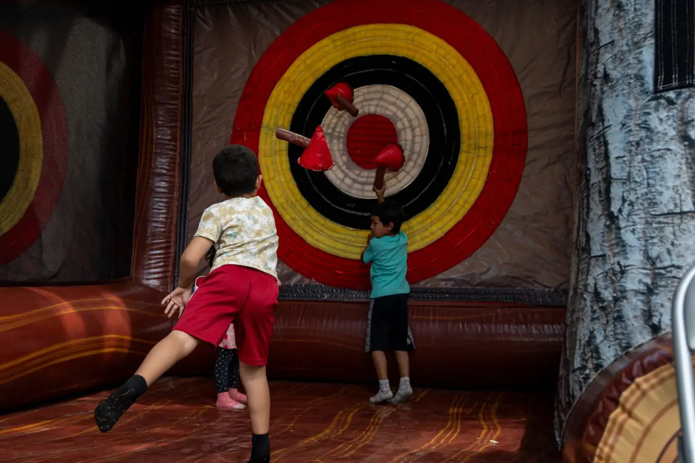 Children playing at inflatable axe-throwing targets