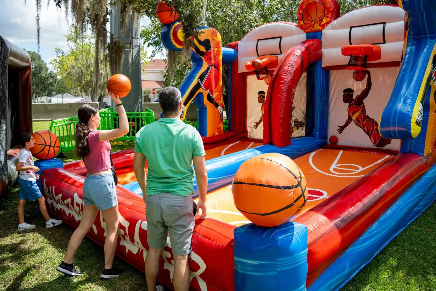 Guests playing an inflatable basketball game outdoors